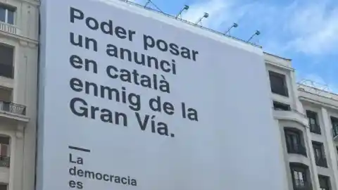 Imagen 1 de El Gobierno cuelga una gran pancarta en catalán en la Gran Vía de Madrid con motivo de los 50 años de democracia en España