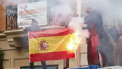 Imagen 1 de Cuatro encapuchados queman una bandera española en Bilbao al paso de la marcha de Ernai por la independencia